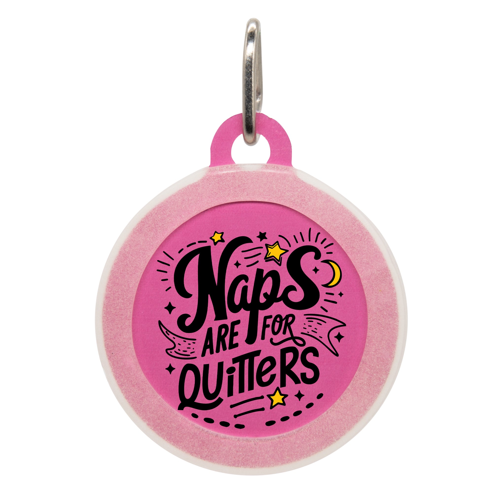 A round pink pet ID tag with playful black text that reads "Naps Are for Quitters," surrounded by stars and a crescent moon, attached to a keyring.