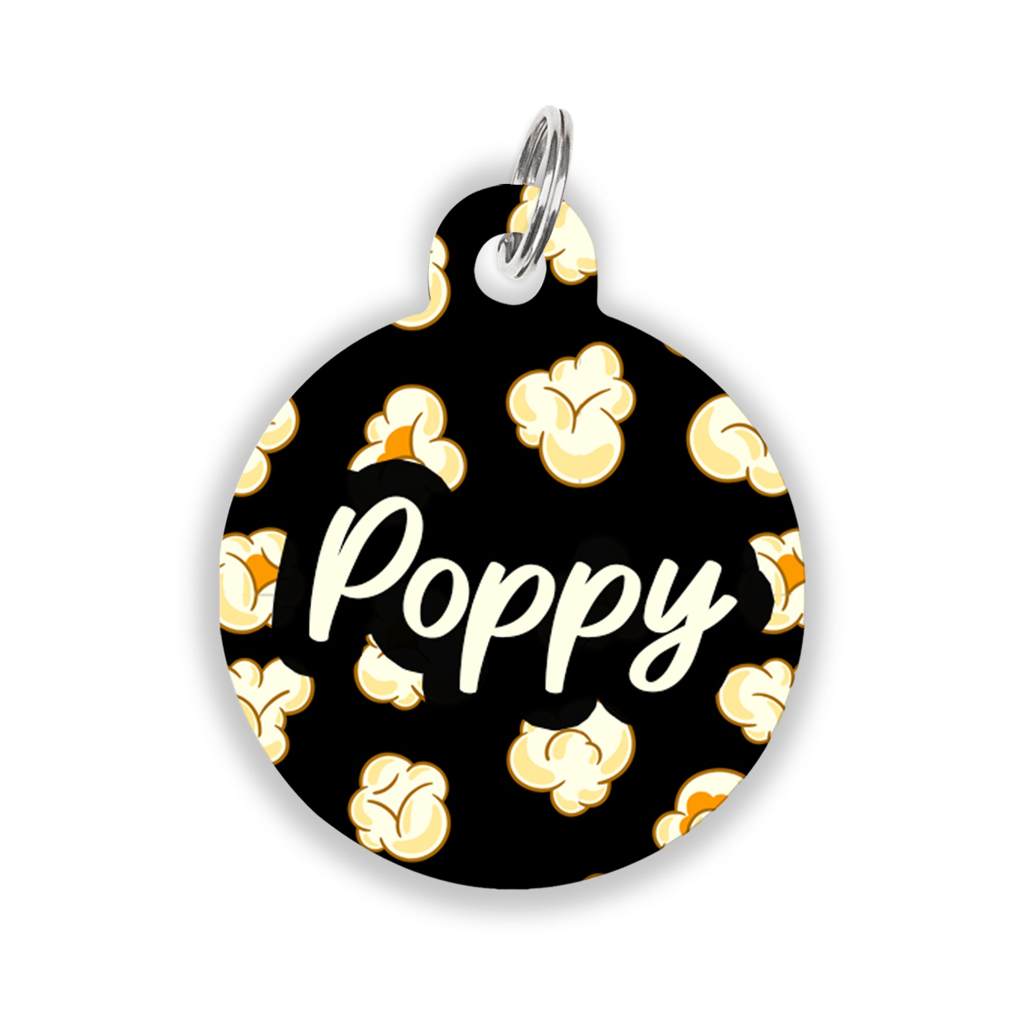 Black pet ID tag with popcorn pattern and the name "Poppy" written in cream white playful font in the center.