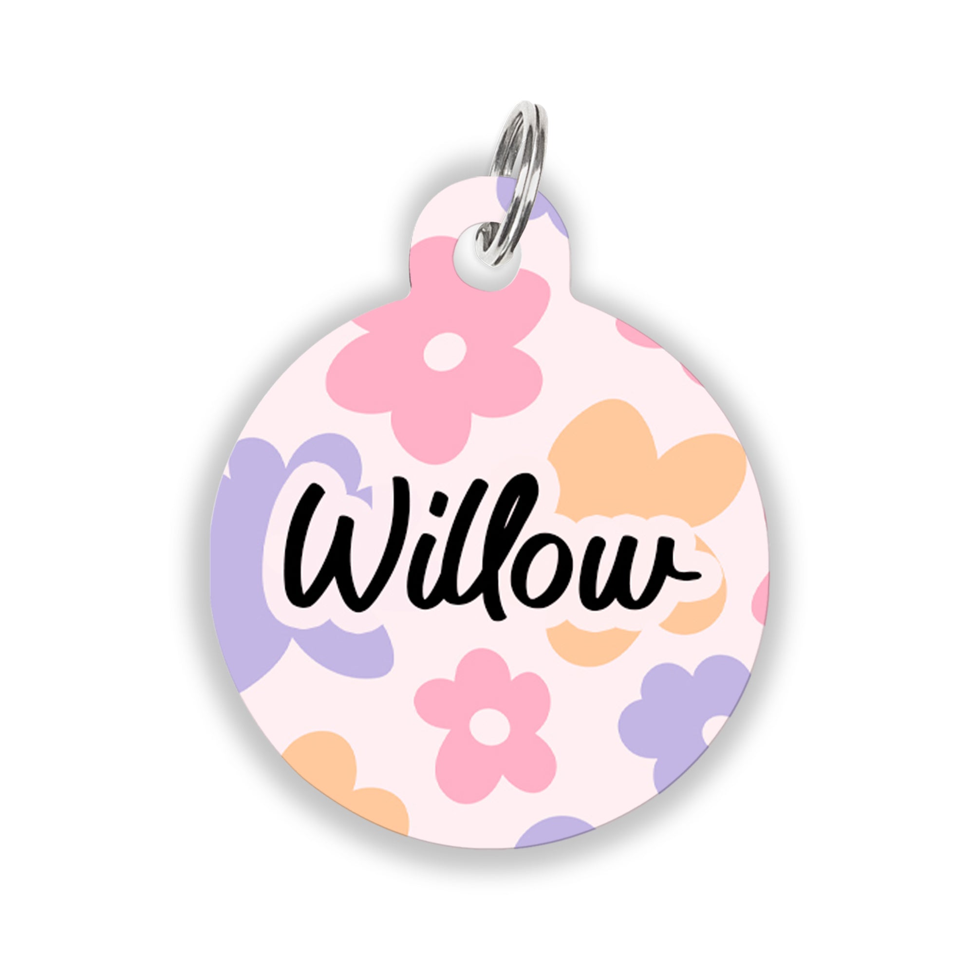 A round pet ID tag with pastel flower designs in pink, purple, and yellow, featuring the name "Willow" in black script on a white background.